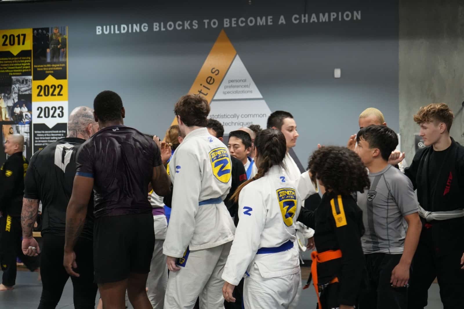 Zenith BJJ students hi-fiving after class.